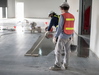 Construction,Worker,Painting,Epoxy,Flooring,Or,Floor,Hardener